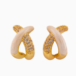 Discover Shooka's elegant crossover hoop earrings for women. Featuring a sophisticated design with cream enamel and sparkling champagne crystals, gold-plated and hypoallergenic.