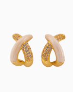 Discover Shooka's elegant crossover hoop earrings for women. Featuring a sophisticated design with cream enamel and sparkling champagne crystals, gold-plated and hypoallergenic.