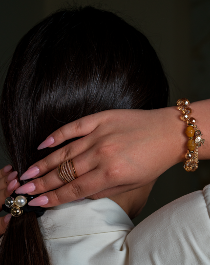 دستبند زنانه شوکا با سنگ آونتورین و کریستال نارنجی، آویز پاپیون طلایی، طراحی دست‌ساز و درخشان.