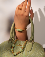 خرید ست مروارید طلایی شوکا شامل گردنبند، دستبند و گوشواره با ترکیب مروارید طلایی، مهره‌های سبز و قهوه‌ای. ست دست‌ساز لوکس مناسب مهمانی و استایل خاص.